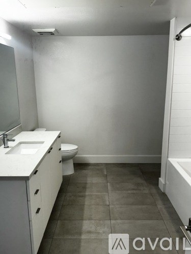 A bathroom with a toilet, sink, and bathtub.