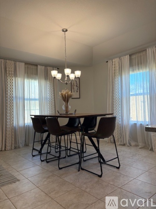 A dining room with a table set for four.
