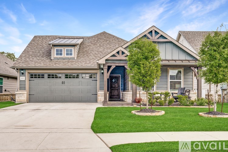 A house with a garage and a driveway in front.