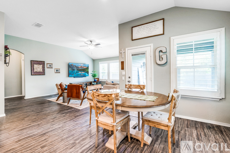 A dining room with a wooden table and chairs.