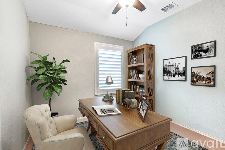 A room with a desk, chair, and bookshelf.