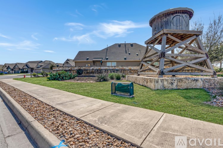 A large wooden water wheel sits in front of a house with a sign that reads "Chosstyne.".