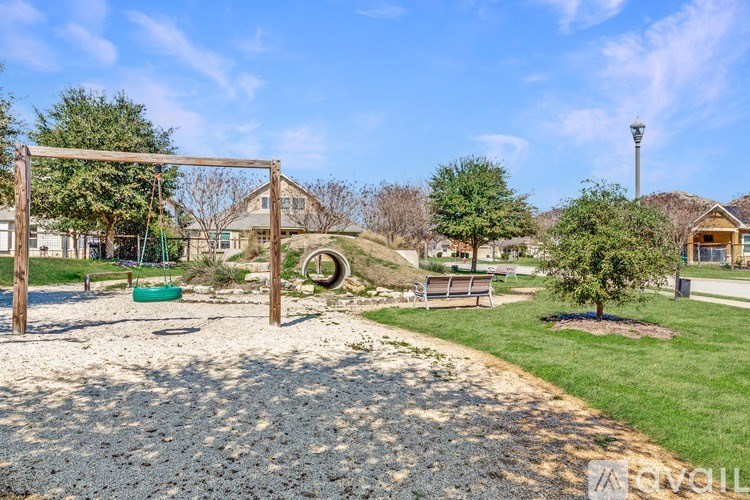 A playground with a swing set and a slide.