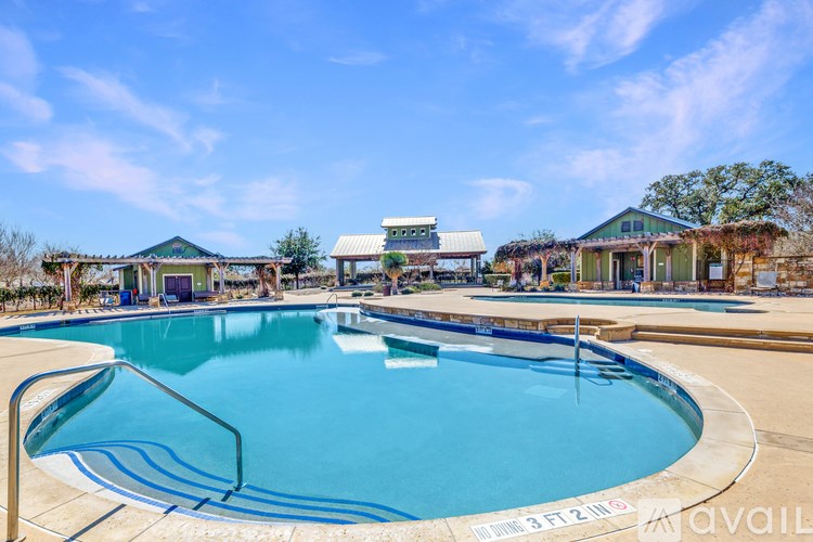 A large outdoor swimming pool with a blue tarp covering the top.