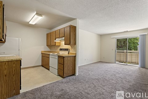 A kitchen area with wooden cabinets and a white refrigerator.