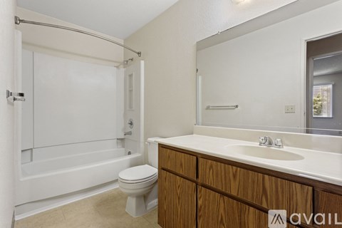 A bathroom with a toilet, sink, and bathtub.