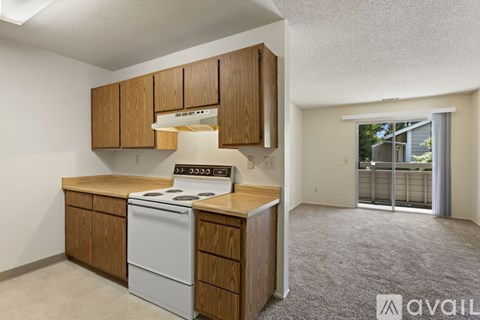 A kitchen with wooden cabinets and a white dishwasher.