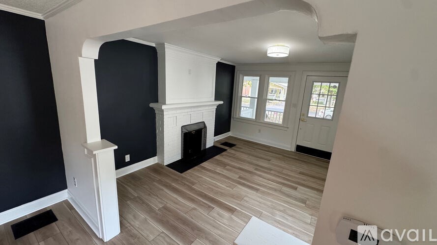 A room with a fireplace and a window.