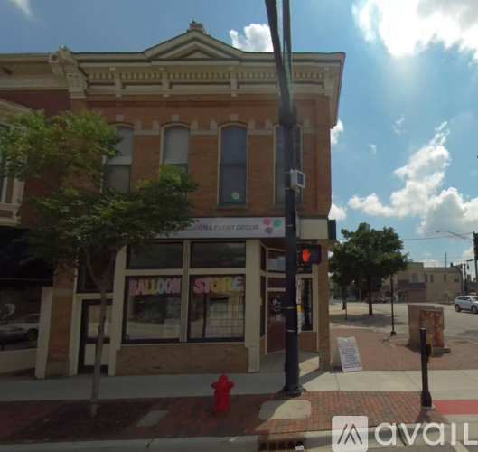A red fire hydrant is in front of a store.
