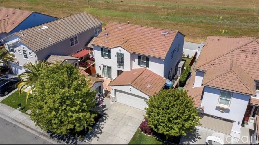 A bird's eye view of a residential area with houses and trees.