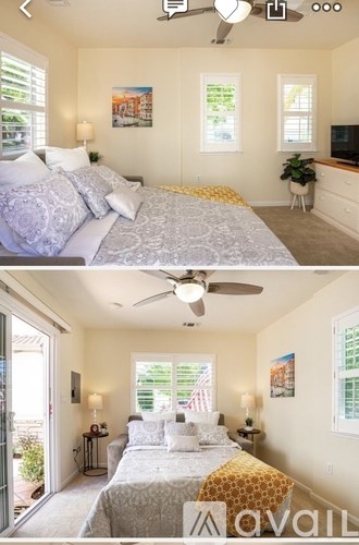 A bedroom with a bed, a ceiling fan, and a window.