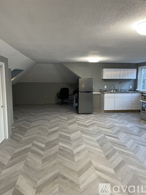 A kitchen with a refrigerator and a countertop.