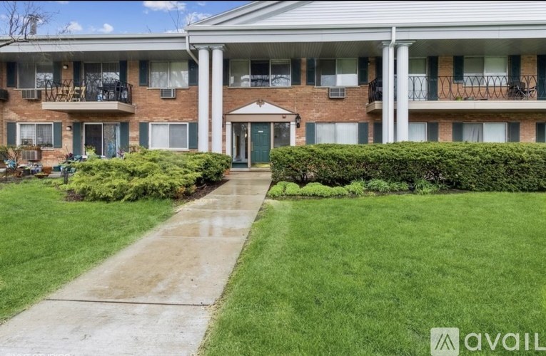 A building with a green lawn in front.