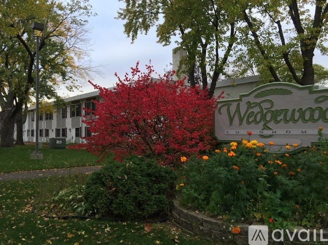 A sign that says Weewood Estates in front of a building.