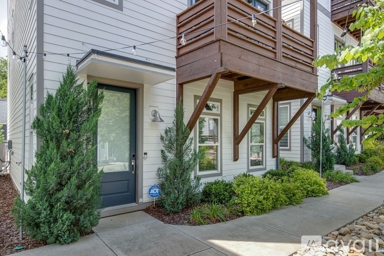 A modern house with a balcony and a blue door.