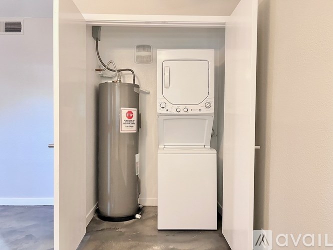 A water heater is installed in a corner of a room.