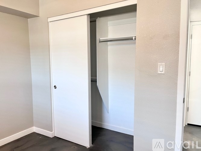 A white door is open to a small, dark room.