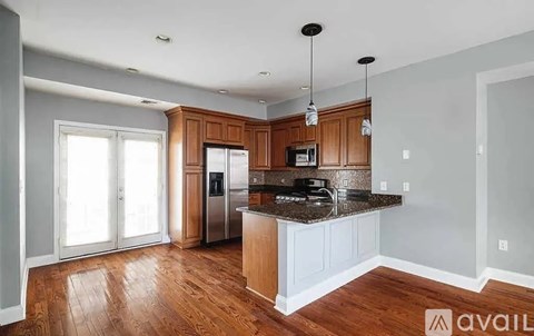 A kitchen with wooden cabinets and a granite countertop.