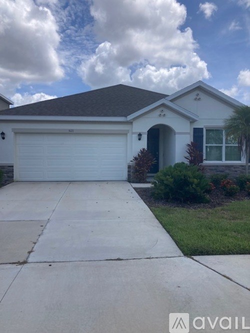 A house with a white garage door and a brown roof.