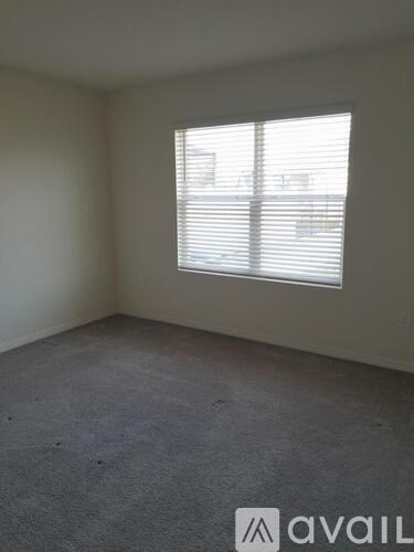 A room with a window covered in blinds.