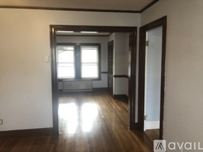 A room with wooden floors and a window.