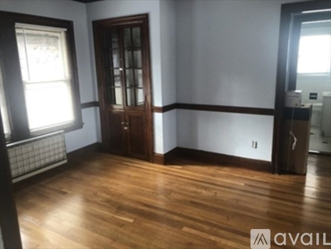 A room with wooden floors and a large wooden door.