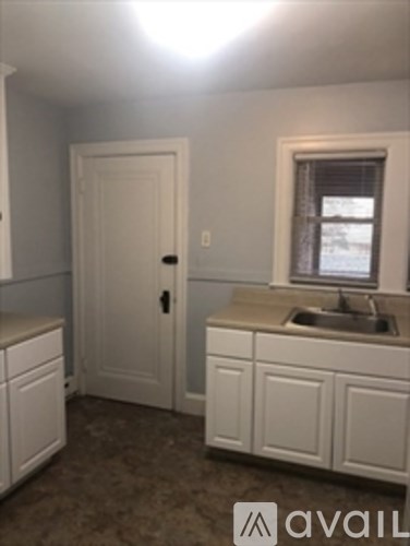 A kitchen with a sink and a window.
