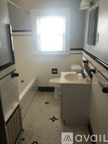 A bathroom with a toilet, sink, and bathtub.