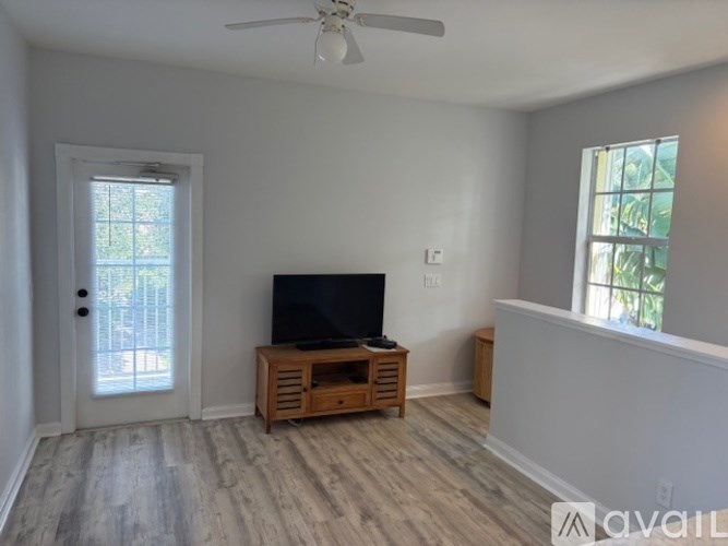 A room with a television and a wooden stand.