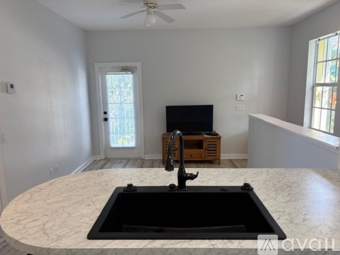 A kitchen with a marble countertop and a sink.