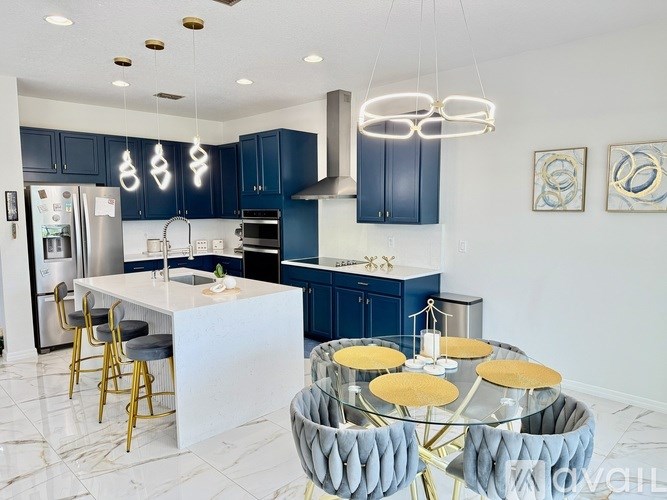 A modern kitchen with dark blue cabinets and a white island.
