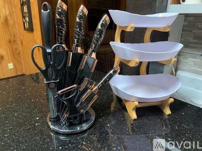 A set of knives and a knife block are on a countertop.