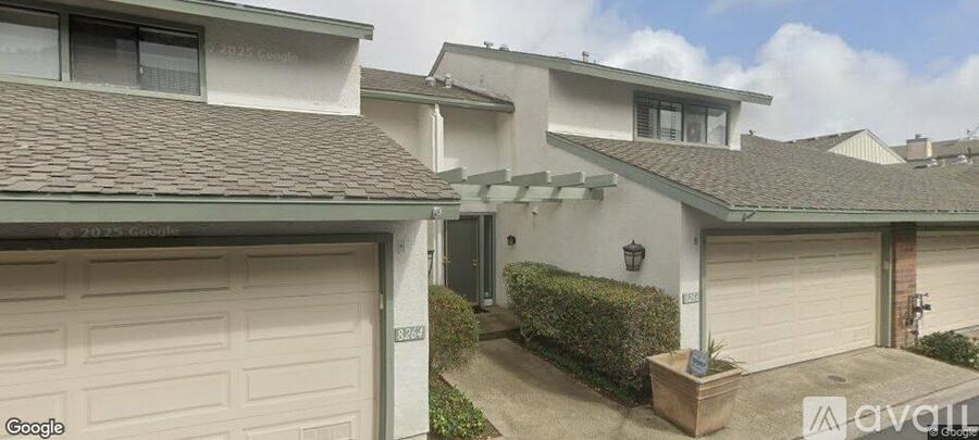 A house with a white garage door is for sale.