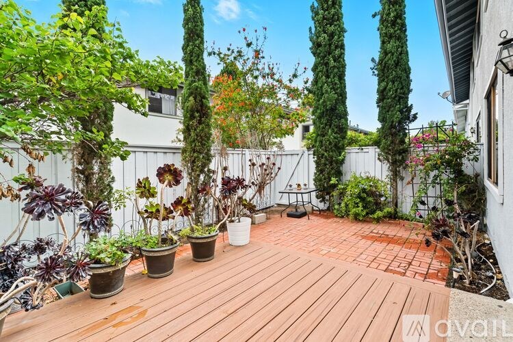 A kitchen with wooden cabinets and a stainless steel refrigerator.