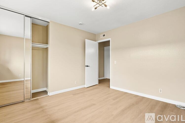 A room with a sliding door and a white door.