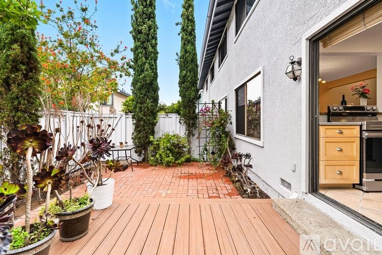 A modern kitchen with a stainless steel oven and wooden drawers.