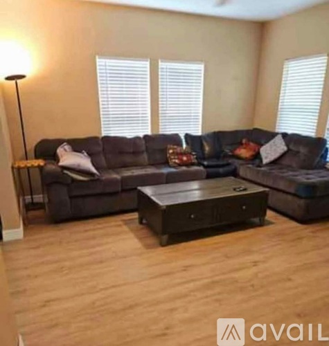 A living room with a grey sectional sofa and a coffee table.