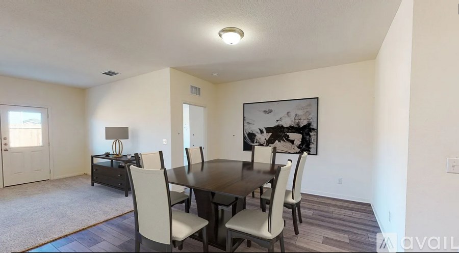 A dining room with a table and chairs.
