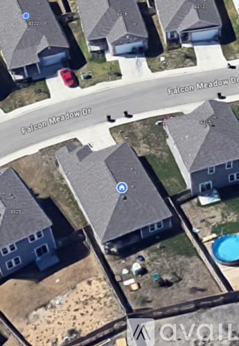 A bird's eye view of Falcon Meadow Drive with houses on either side.