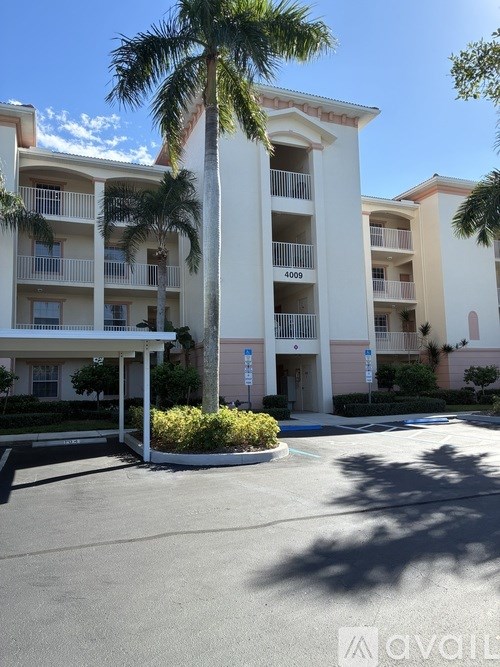 A tall palm tree stands in front of apartment building 4009.