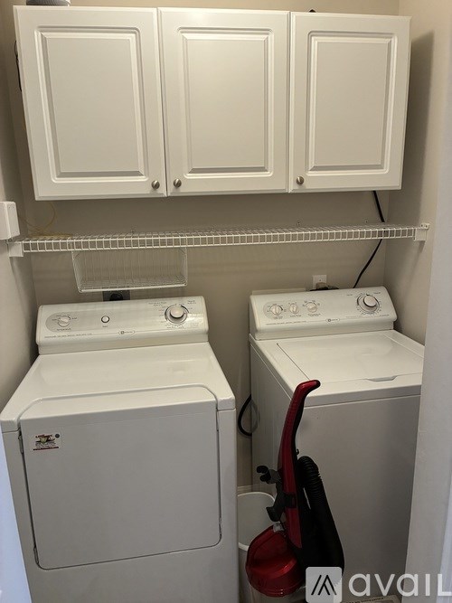 A small laundry room with a washer and dryer.