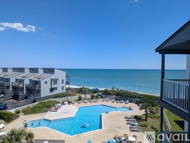 A large swimming pool with a view of the ocean.