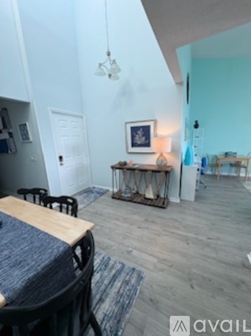 A dining table with chairs and a sofa in a room.