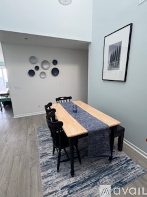 A dining room with a wooden table and chairs.