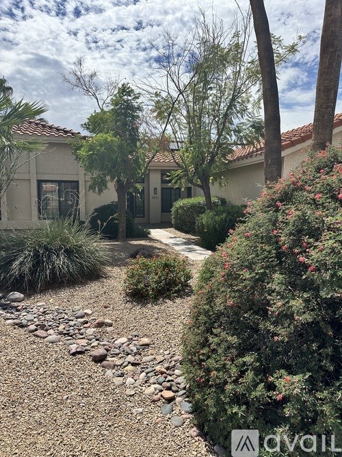 A house with a garden in front of it.