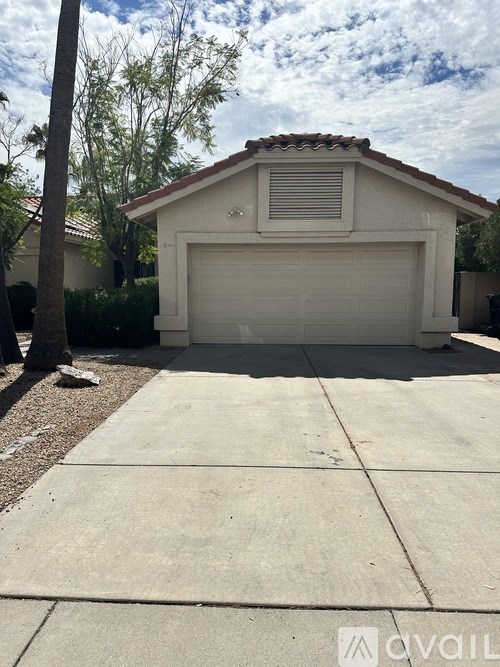 A house with a garage door and a driveway.