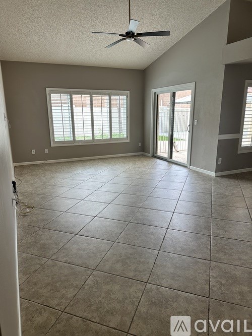 A room with tile flooring and a ceiling fan.