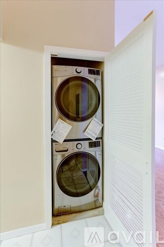A washing machine is installed in a small alcove.