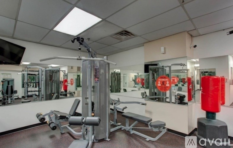A gym with a variety of equipment including a leg press machine.