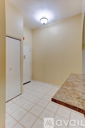 A room with a marble bench and a tiled floor.